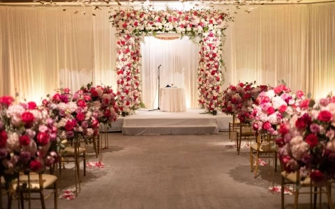 a wedding ceremony with chairs and flowers