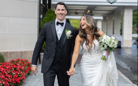 a man and woman holding hands and walking