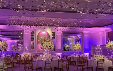 a room with tables and chairs and flowers