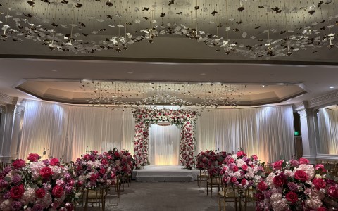 a wedding ceremony with chairs and flowers
