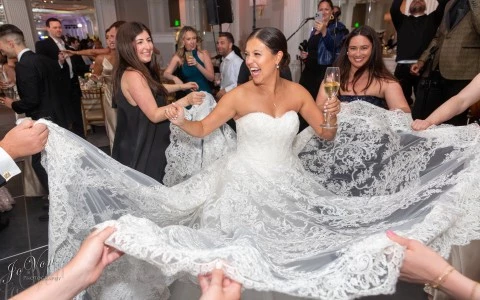a woman in a wedding dress dancing with other people