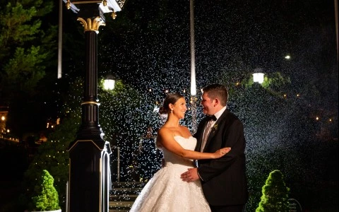 a man and woman in wedding dress standing in front of a clock