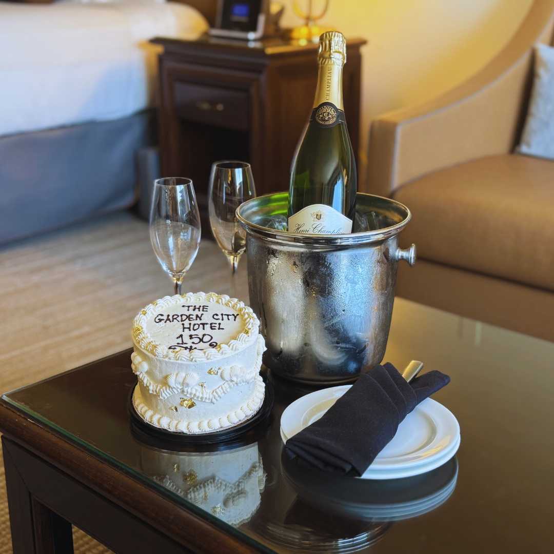 a champagne bottle in a bucket and glasses on a table