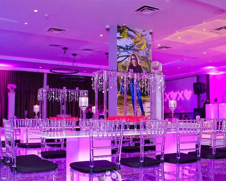 a room with purple lights and tables and chairs