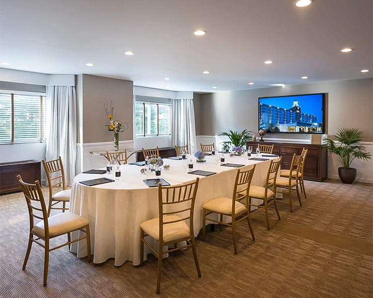 a room with a large round table and chairs
