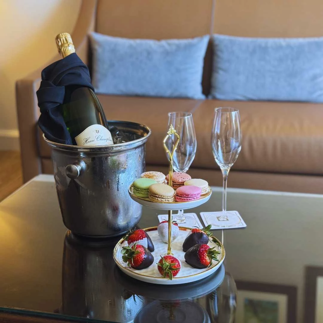 a champagne bottle and desserts on a table