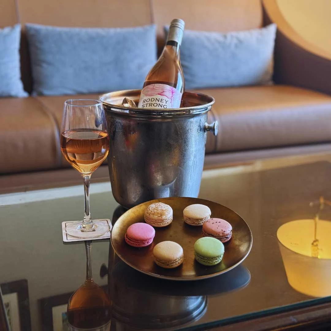 a wine bottle and a plate of food on a table