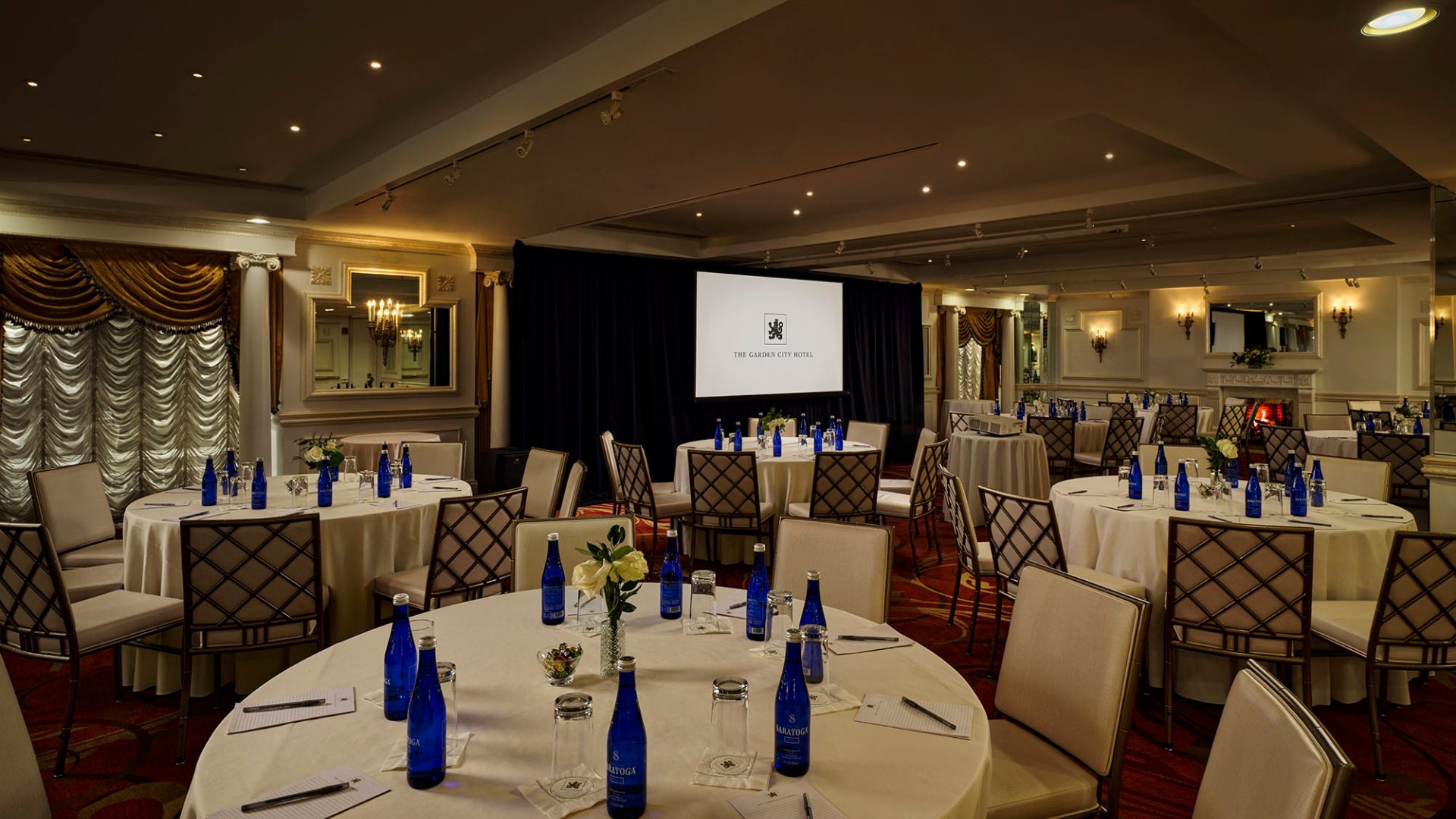 a room with tables and chairs and blue bottles