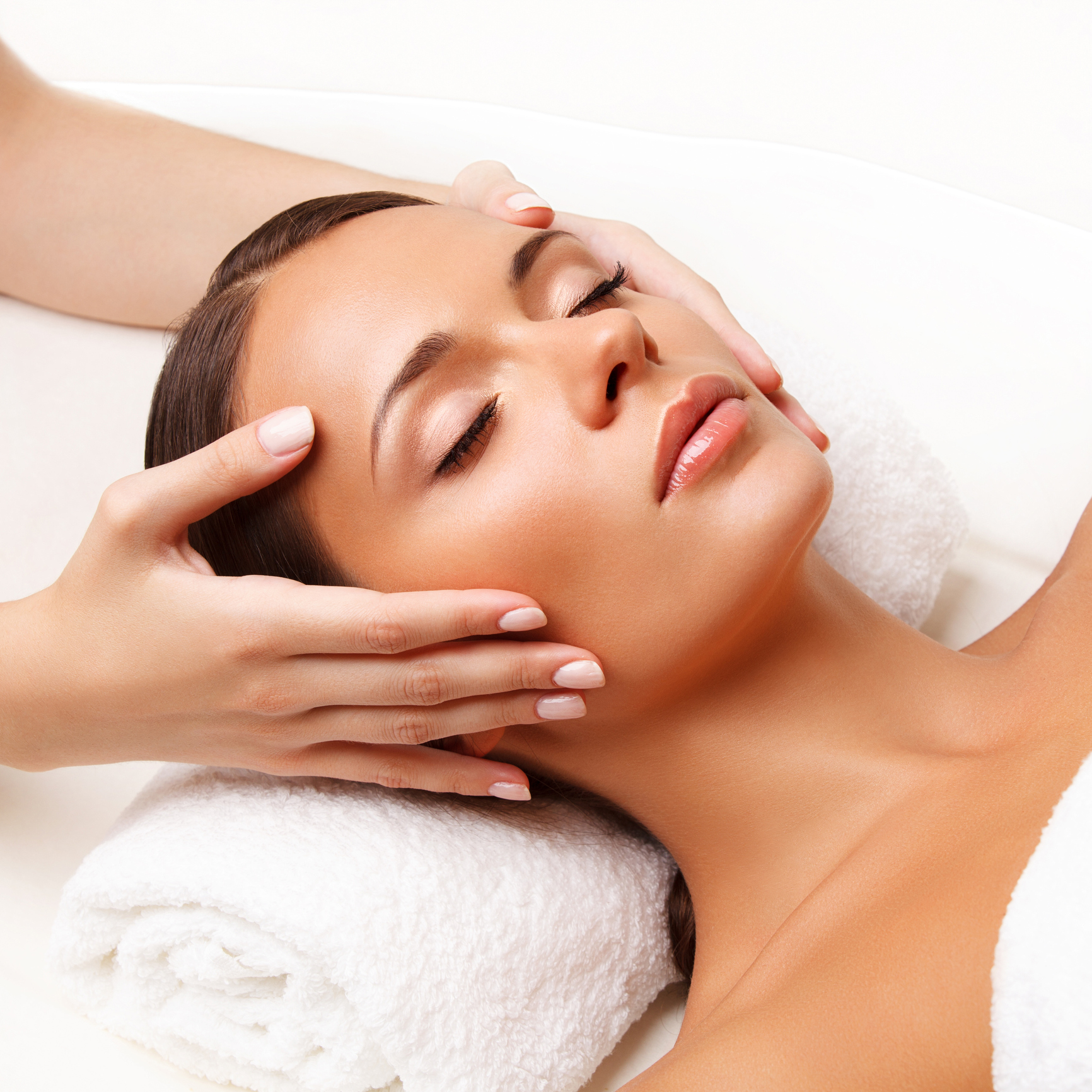 a woman lying on her back with her hand on her face
