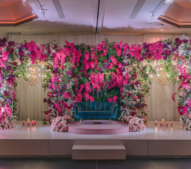 a stage with flowers and a couch