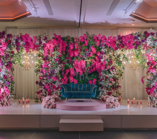 a stage with flowers and a couch