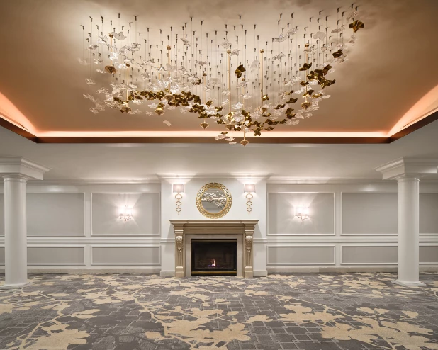 a room with a fireplace and chandelier