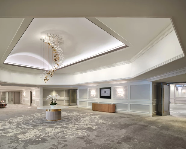 a room with a chandelier and flowers