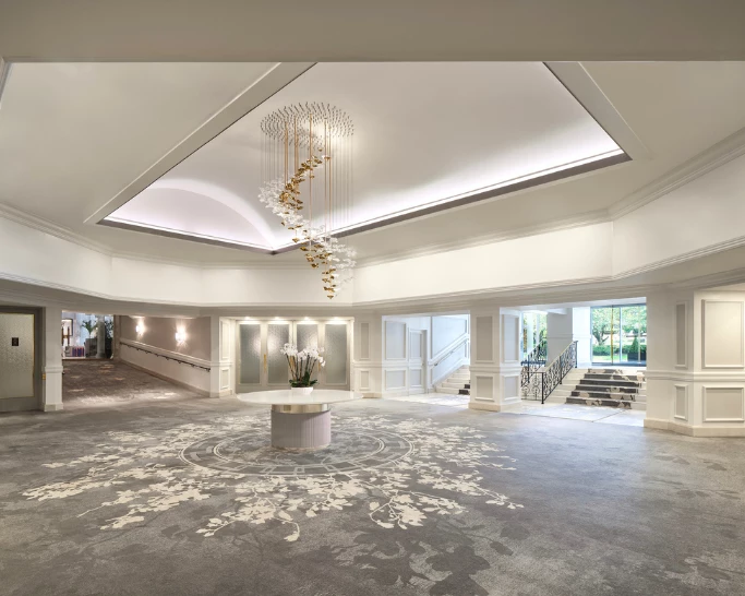 a large room with a chandelier and a round table