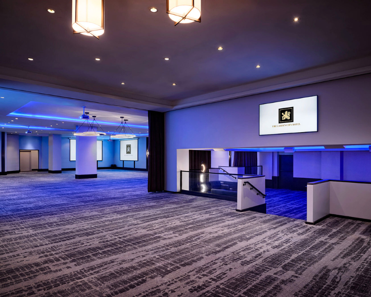 a room with a screen and a staircase