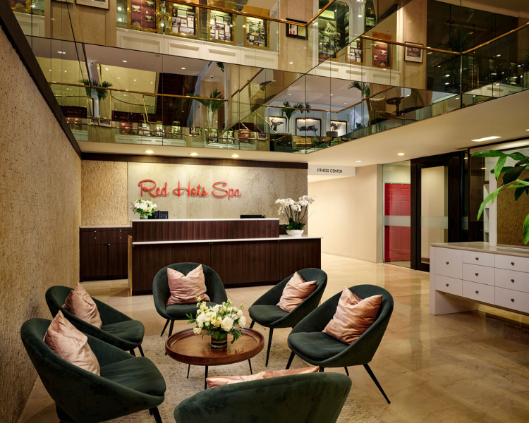 a lobby with a reception desk and chairs