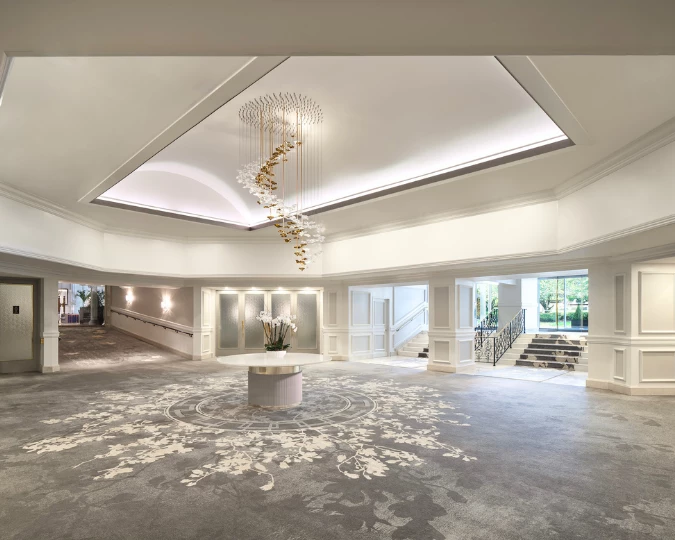 a large room with a chandelier and flowers