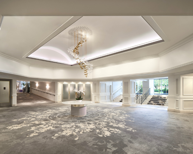a large room with a chandelier and flowers