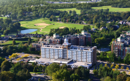 a large building with trees and grass