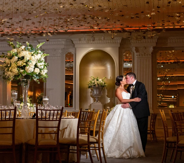 a man and woman kissing in a room