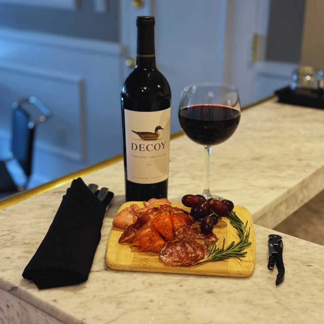a glass of wine and food on a counter