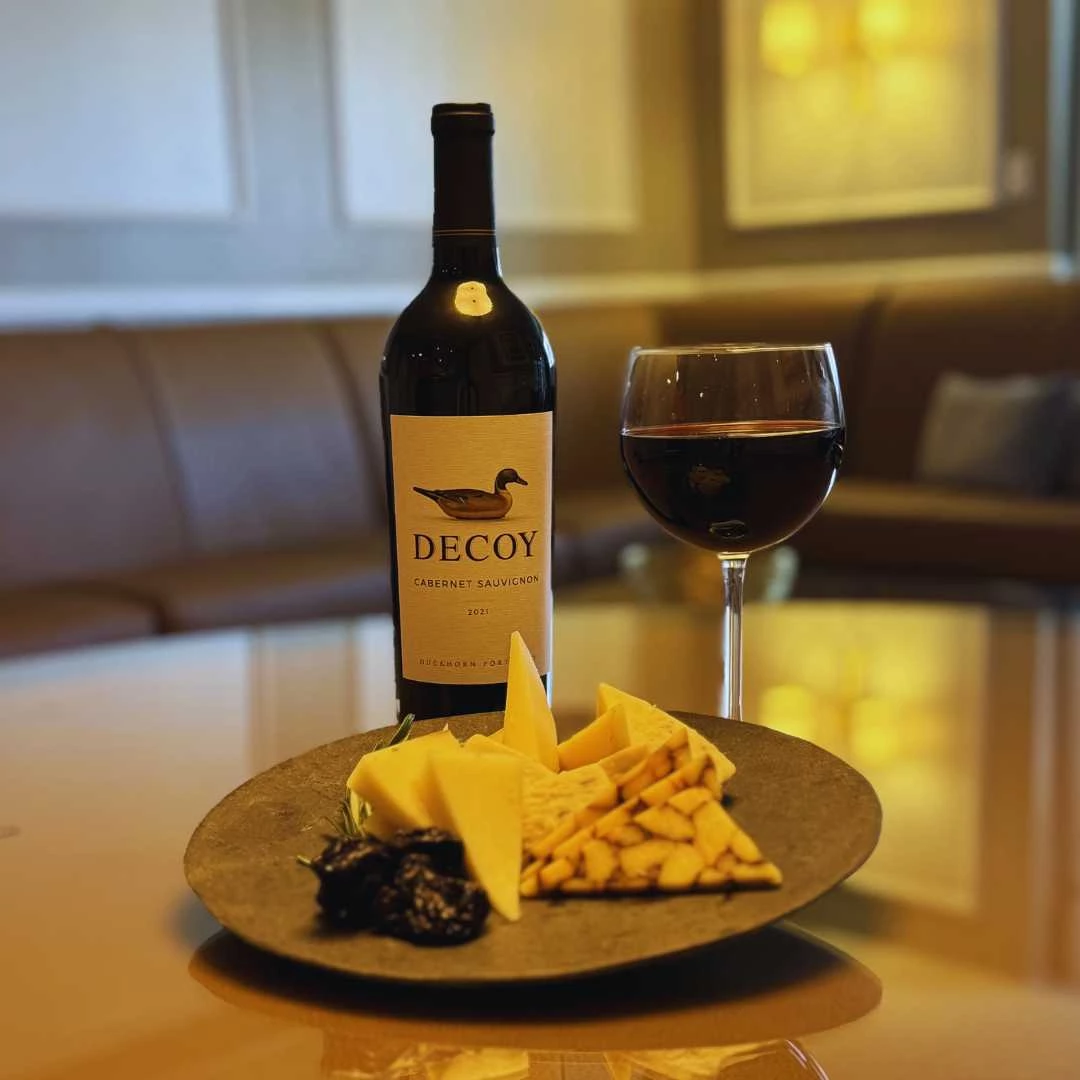 a plate of food and a glass of wine