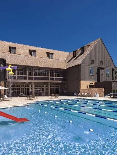a swimming pool with a slide and a building