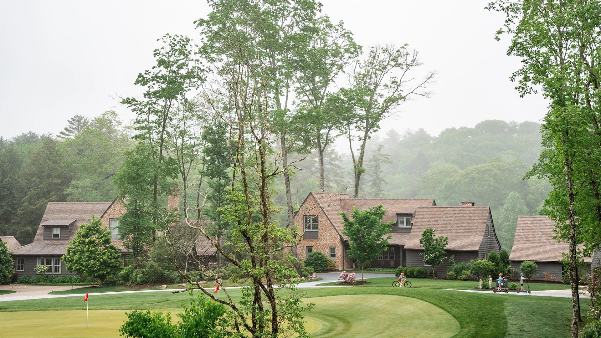 a house with a golf course and a house with trees
