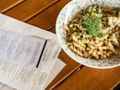 a bowl of pasta and a piece of paper next to a receipt