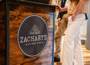 a sign on a wooden surface