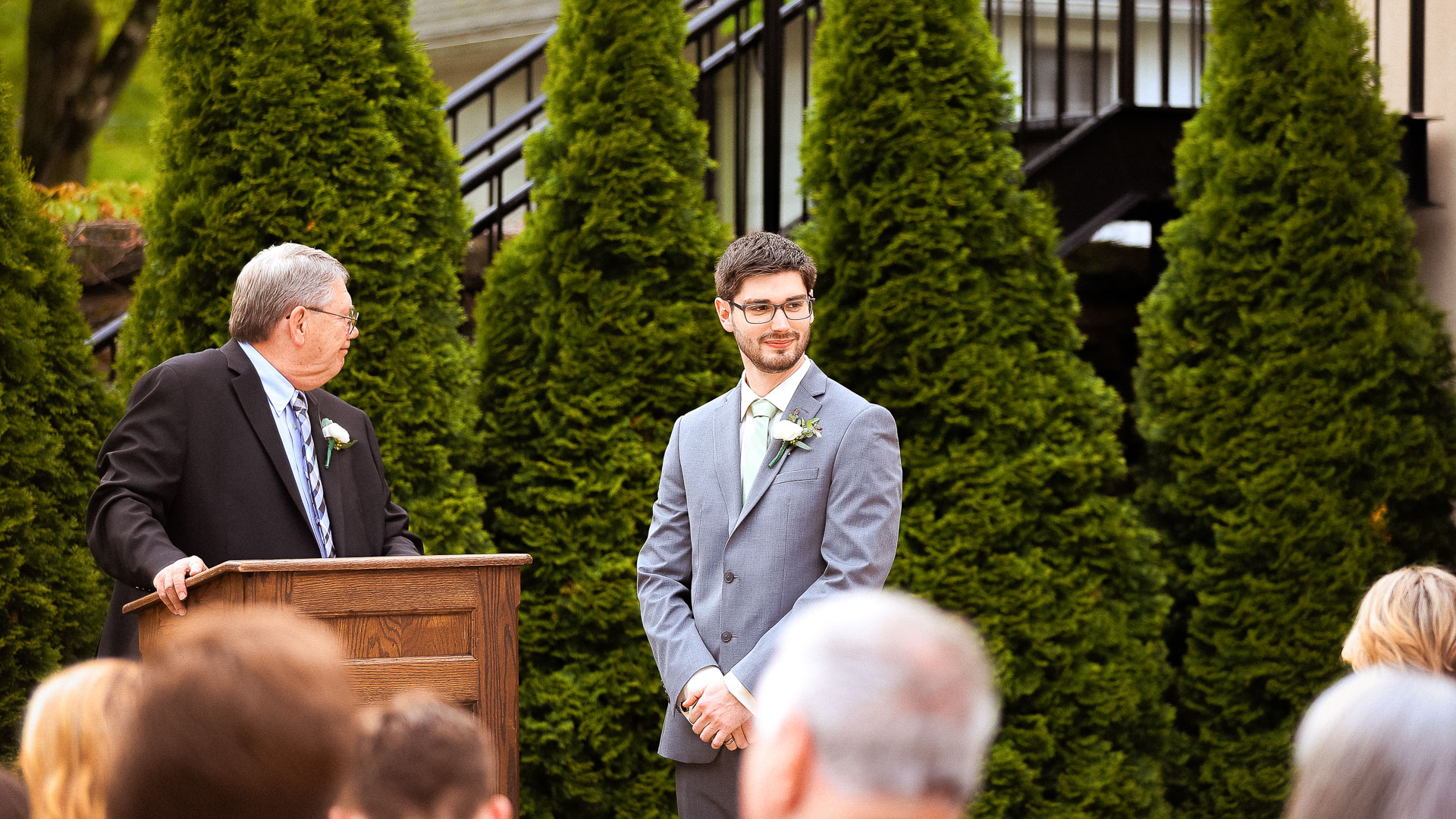 a man in a suit standing in front of a podium