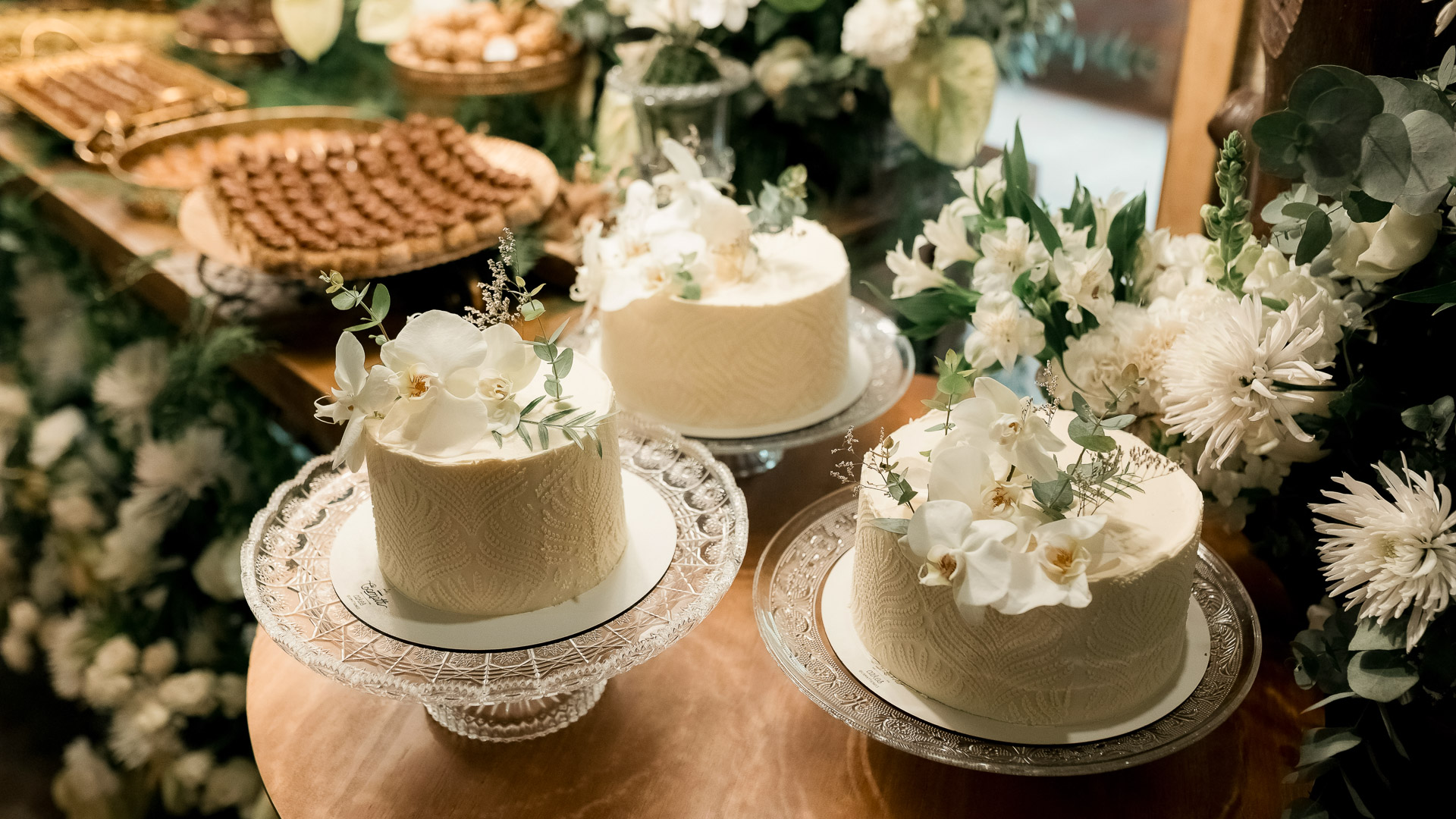 a group of cakes on plates with flowers