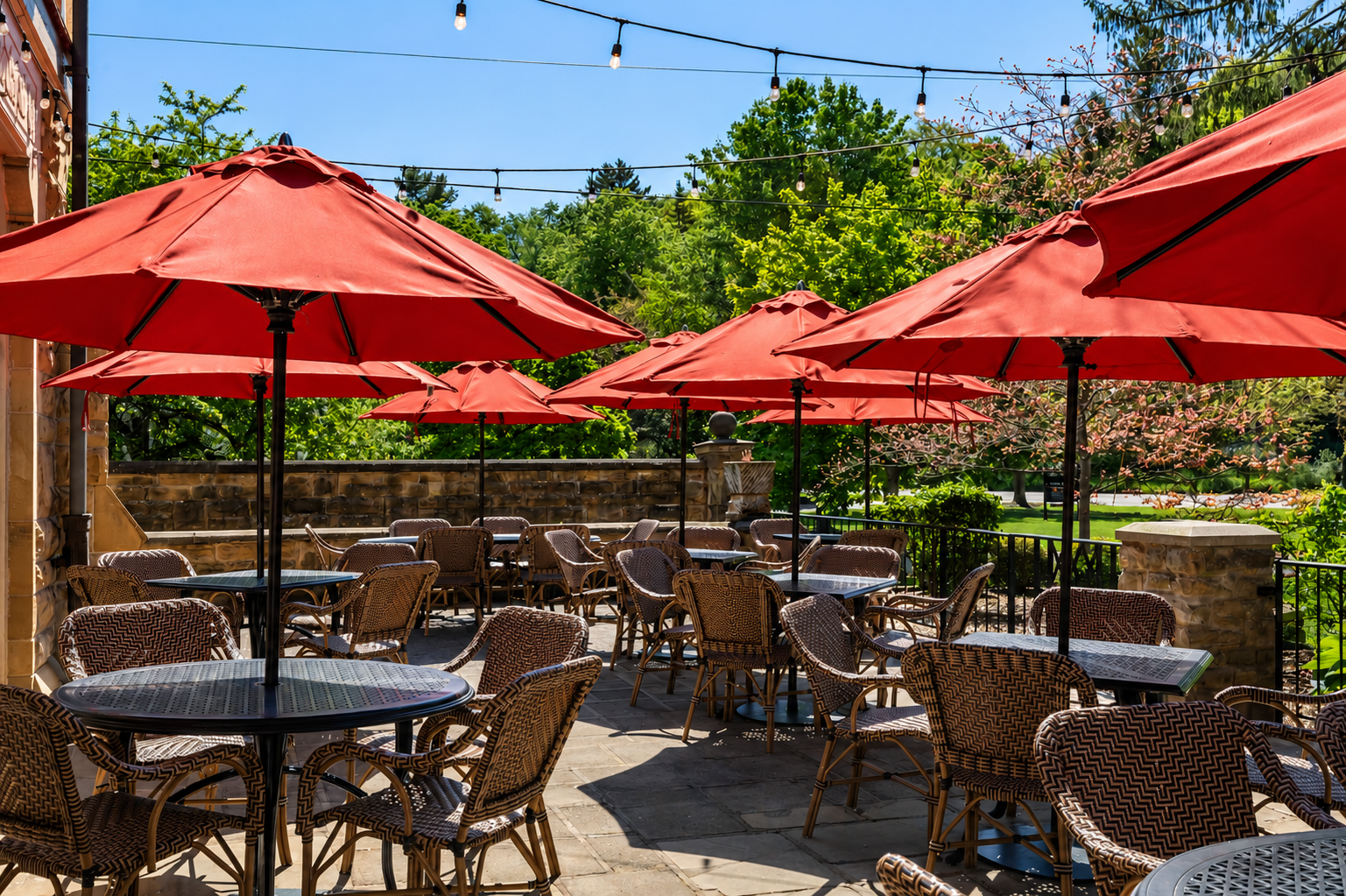 a group of tables and chairs with umbrellas