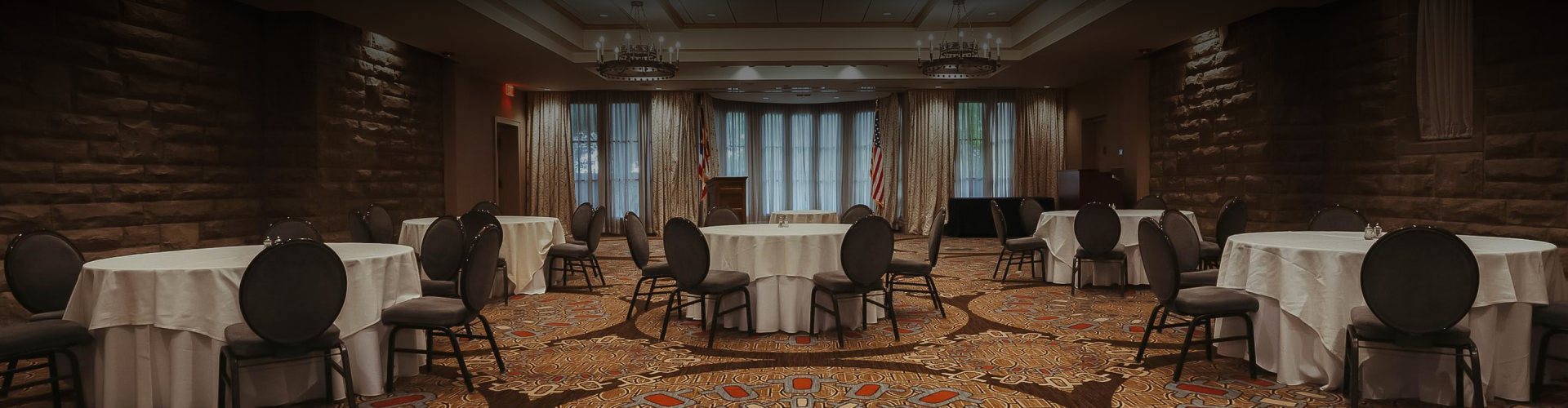 a round table in a room with chairs and a podium