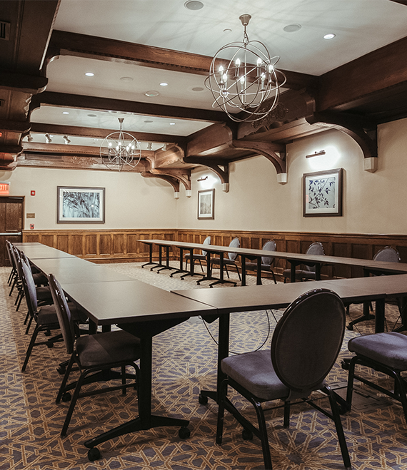 a room with long tables and chairs