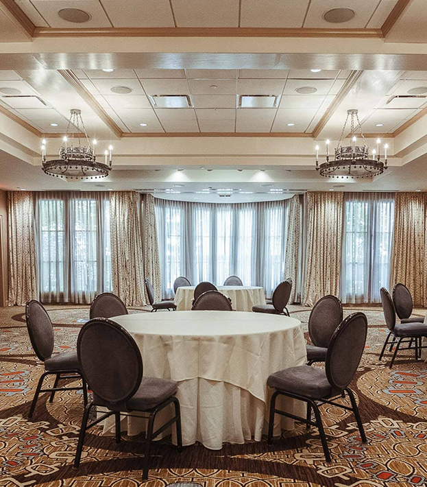 a room with a round table and chairs