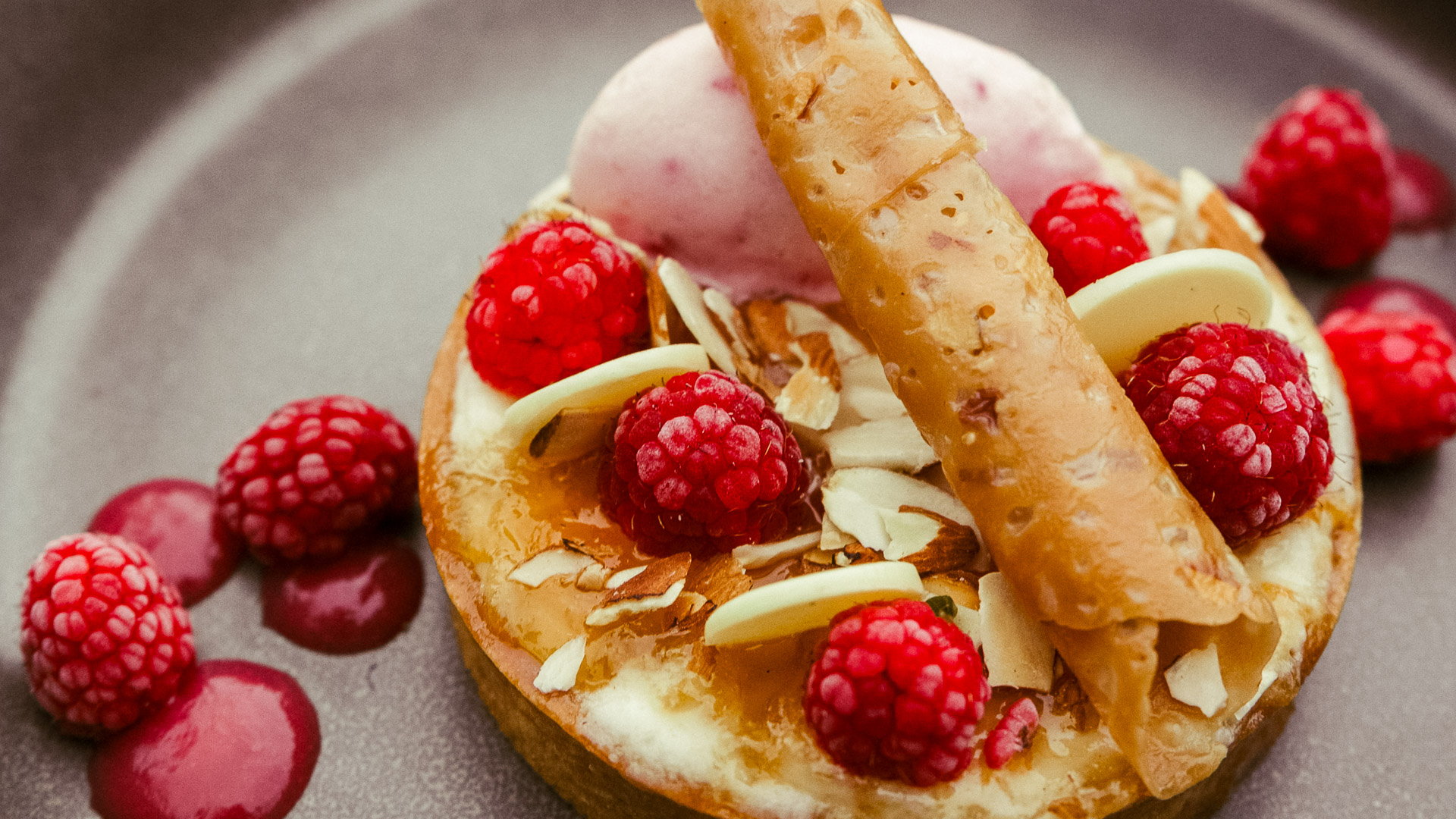 a dessert with raspberries and a stick
