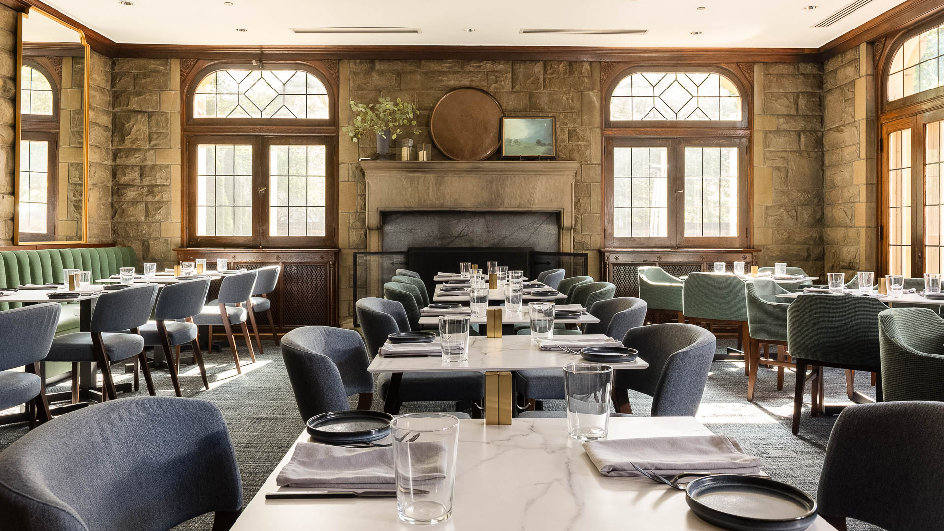 a room with a fireplace and tables