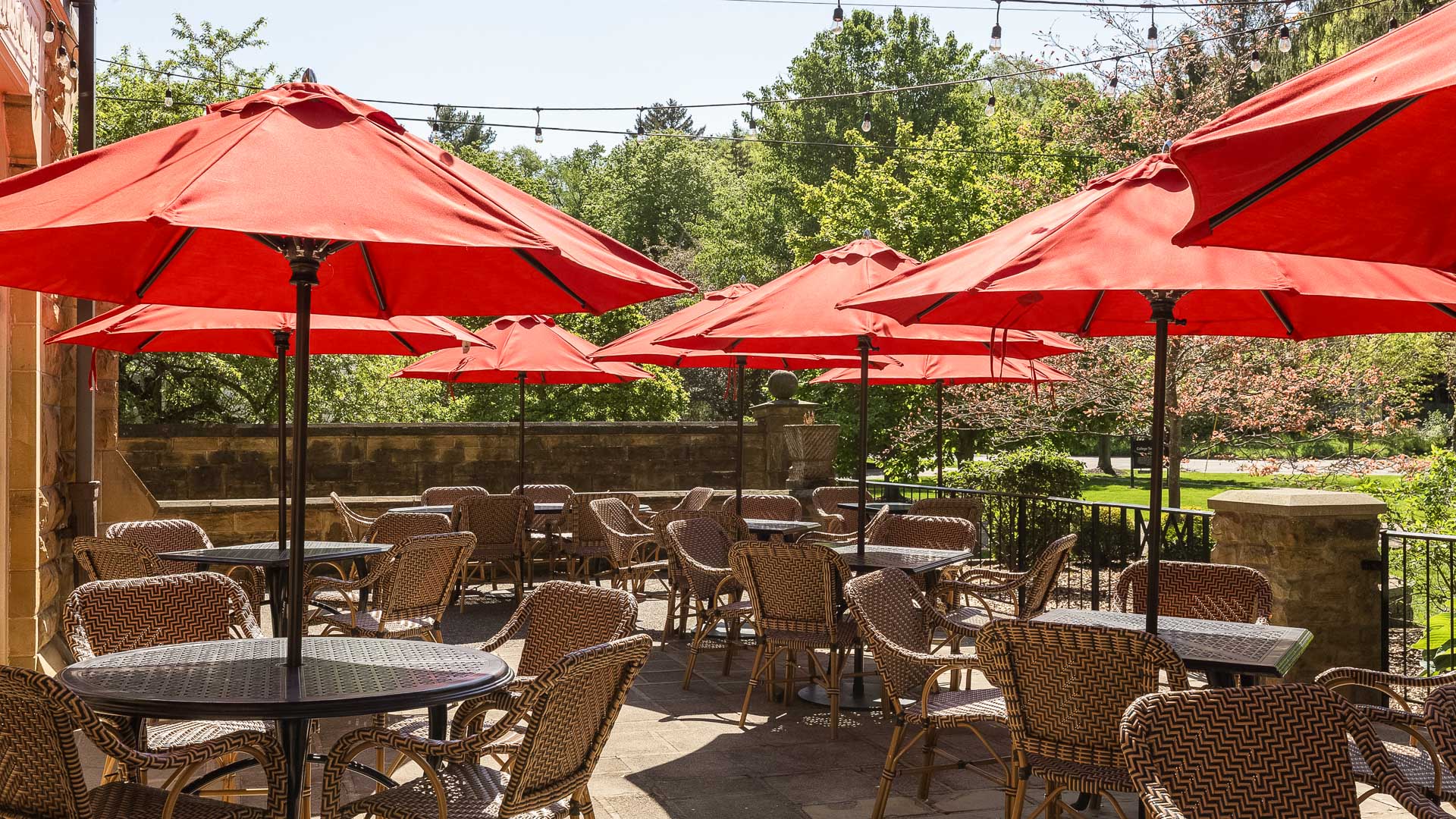 a group of tables and chairs with umbrellas