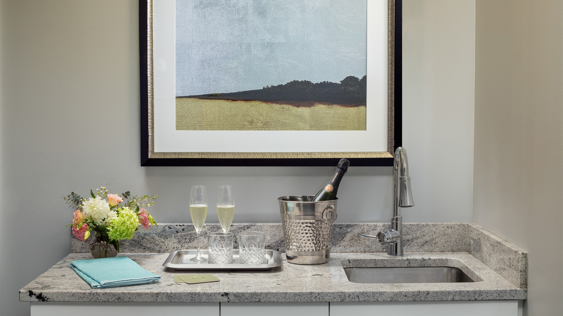 a champagne bottle in a bucket on a counter