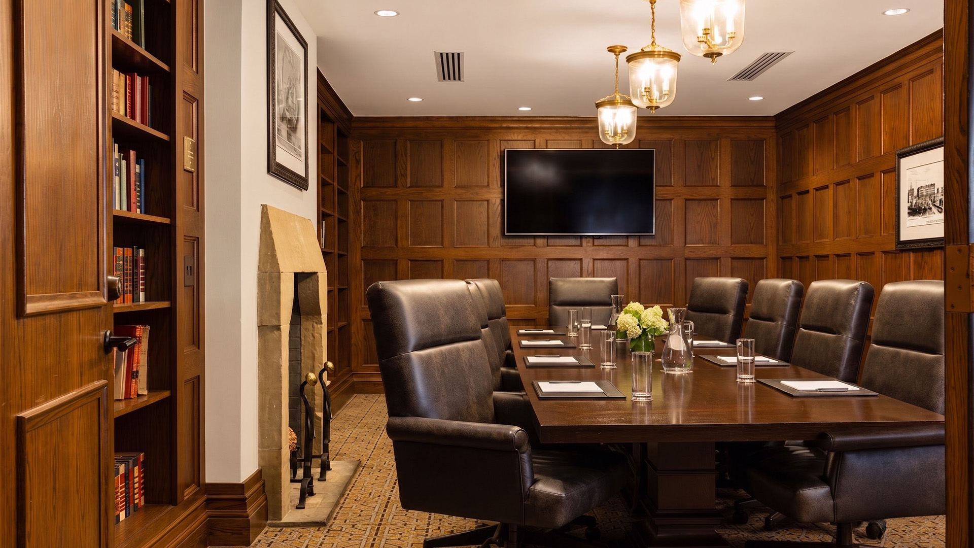 a conference room with a fireplace and a table