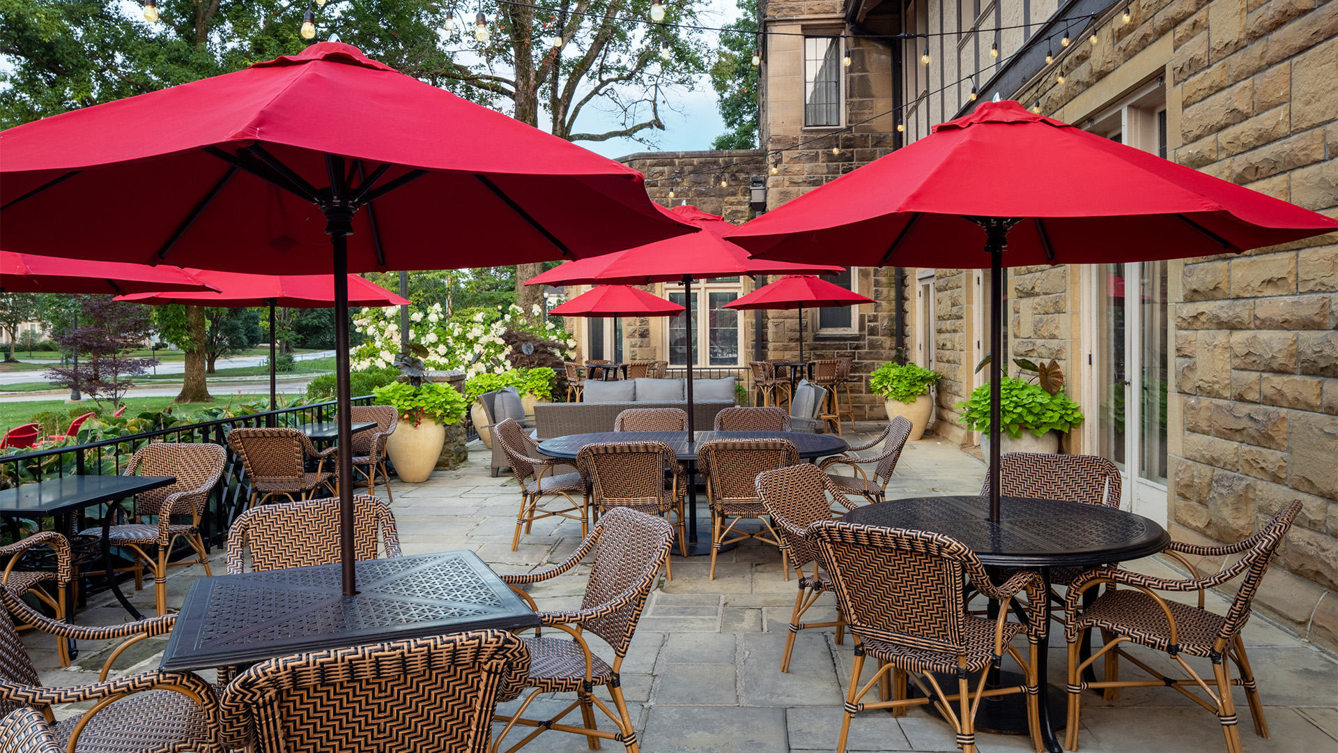 a patio with tables and umbrellas