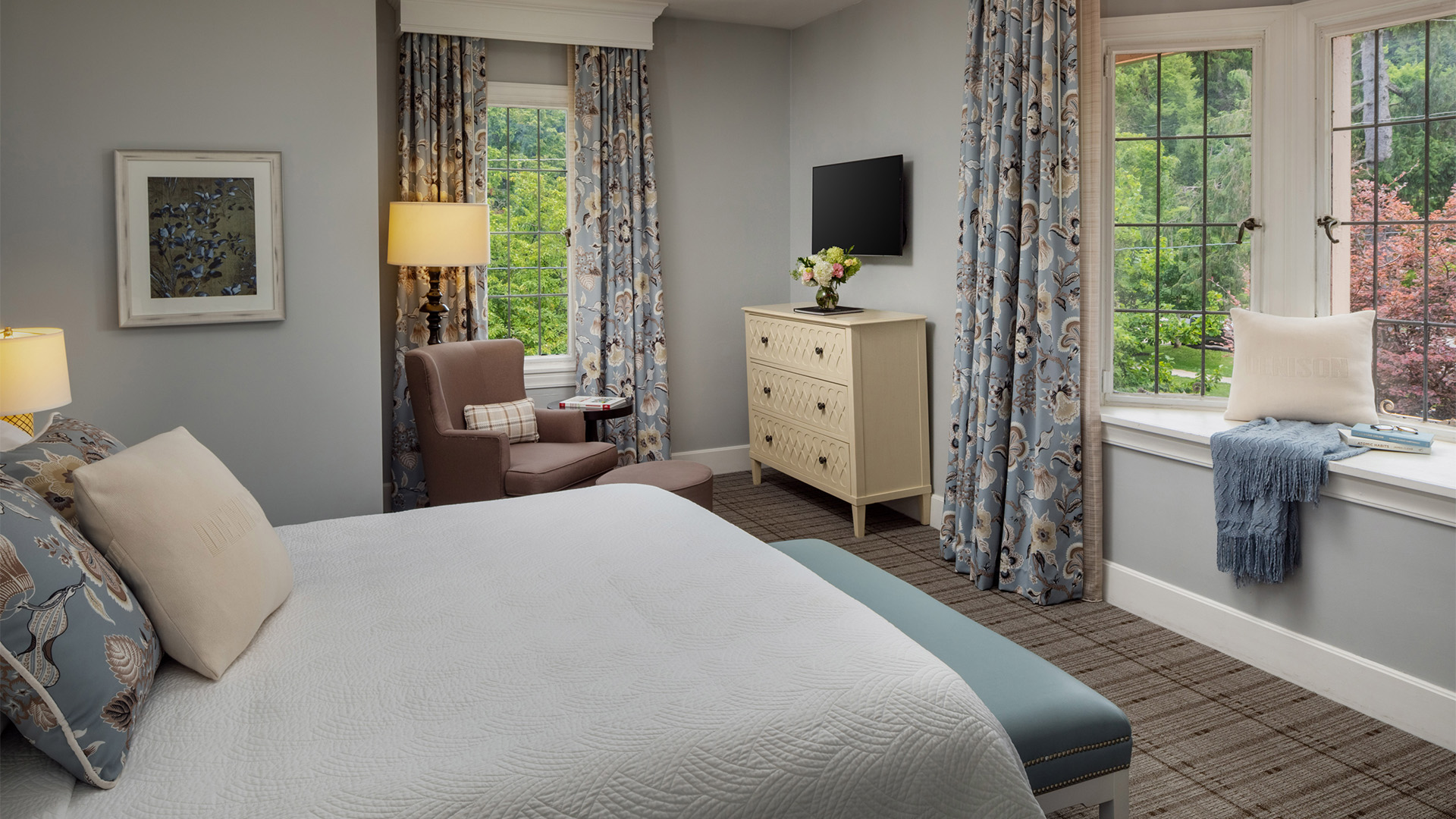a bedroom with a bed and a dresser and a tv