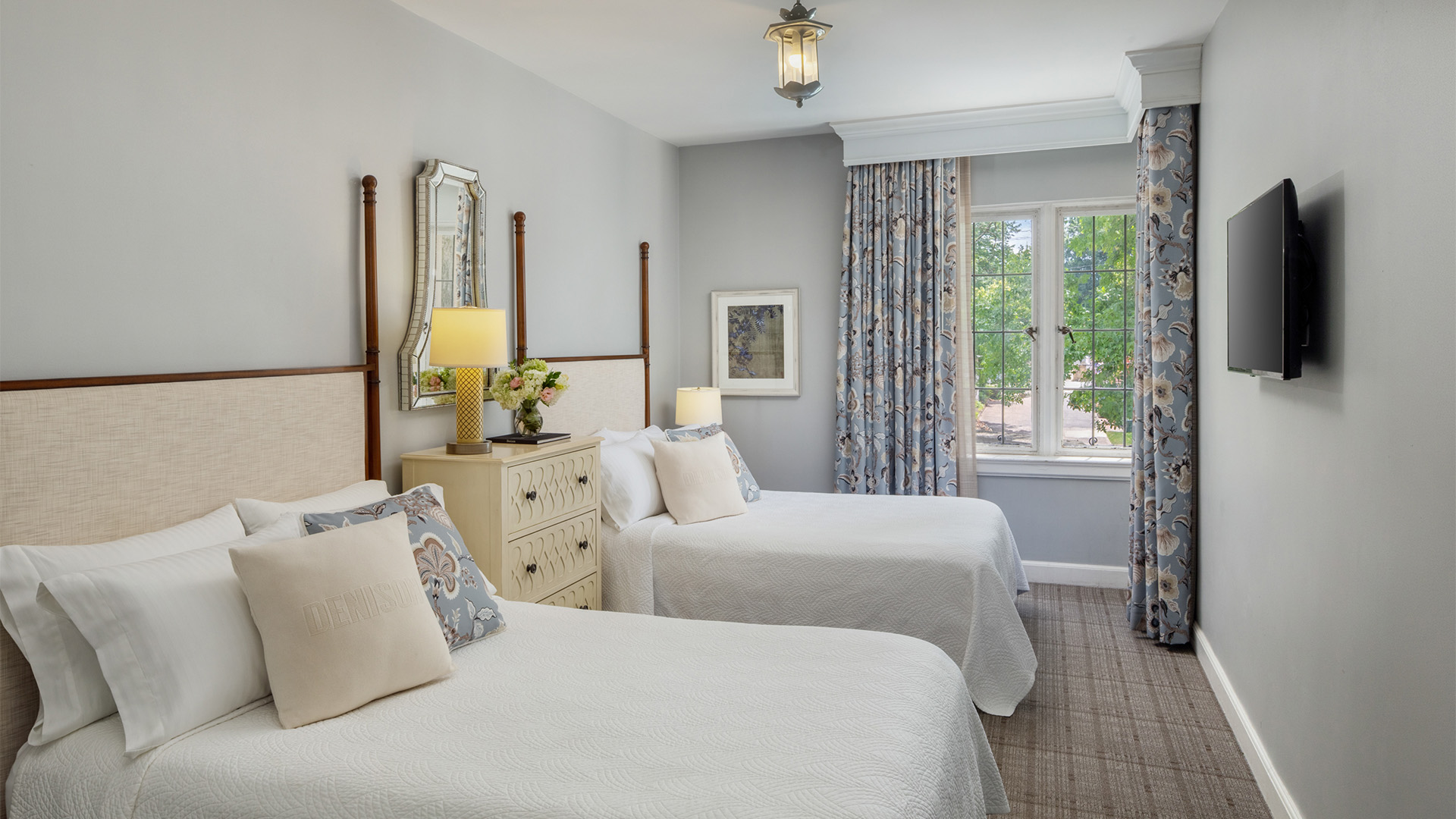 a room with two beds and a window