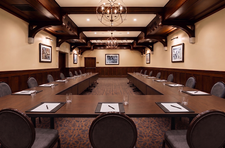 a room with a long table and chairs