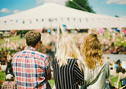 a group of people sitting in front of a large crowd