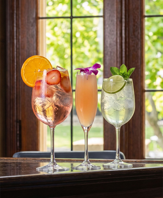 a group of drinks in wine glasses