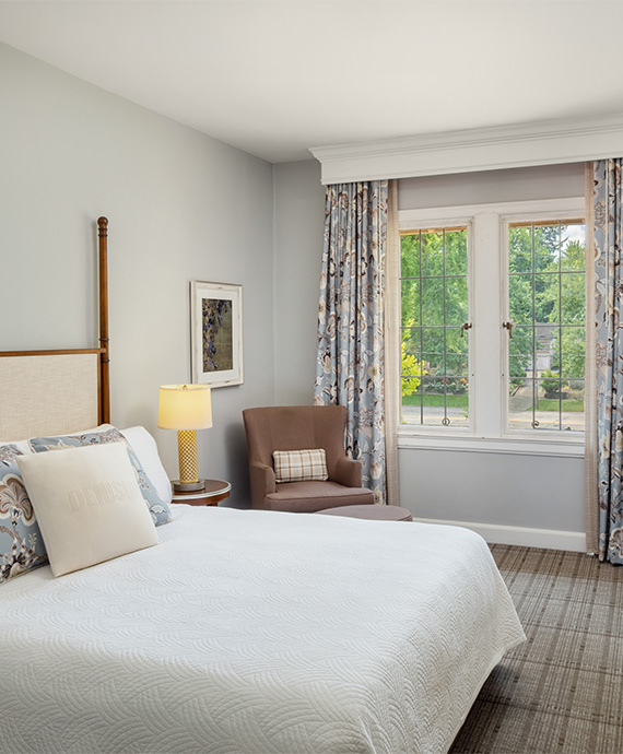 a bedroom with a bed and a chair