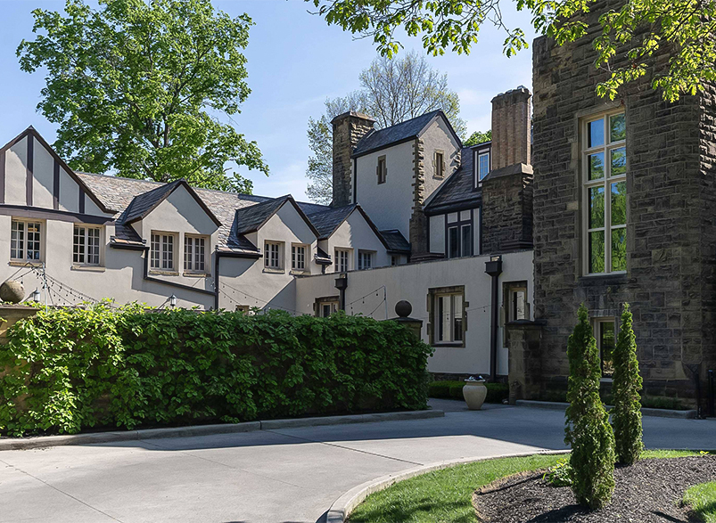 a house with a stone wall and a stone wall