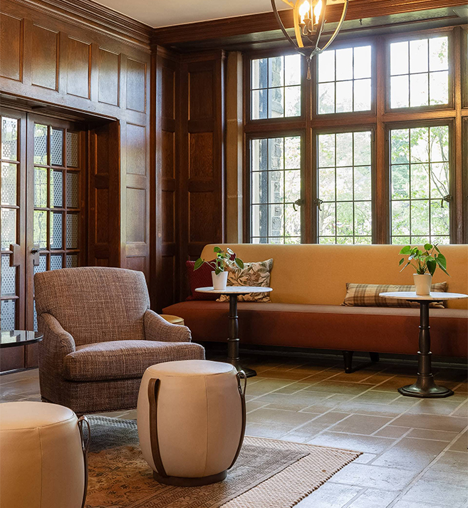 a room with a couch and chairs